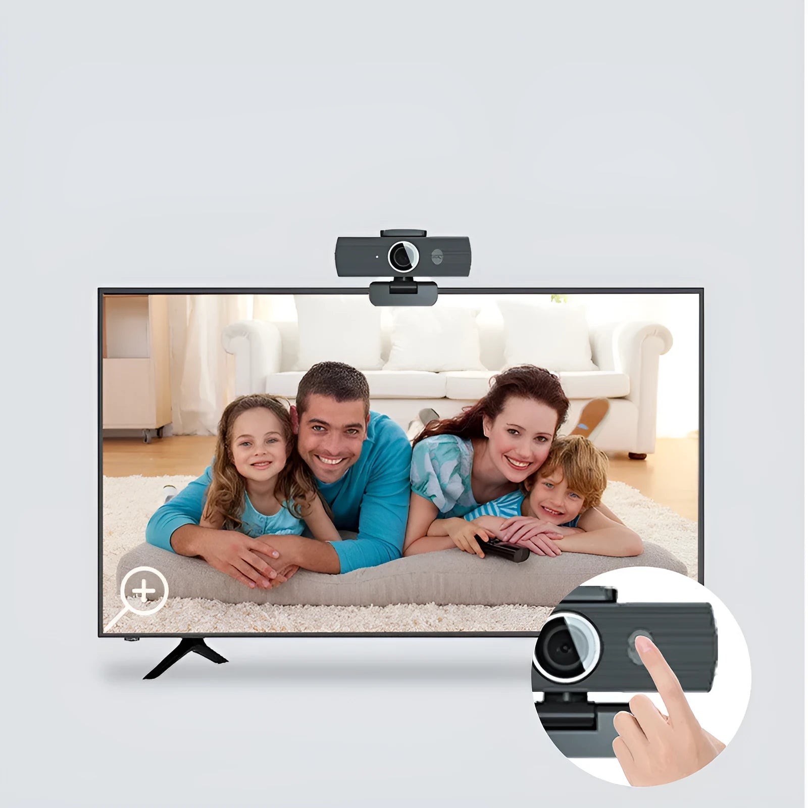Black USB webcam with magnetic privacy cover on a desk next to a laptop