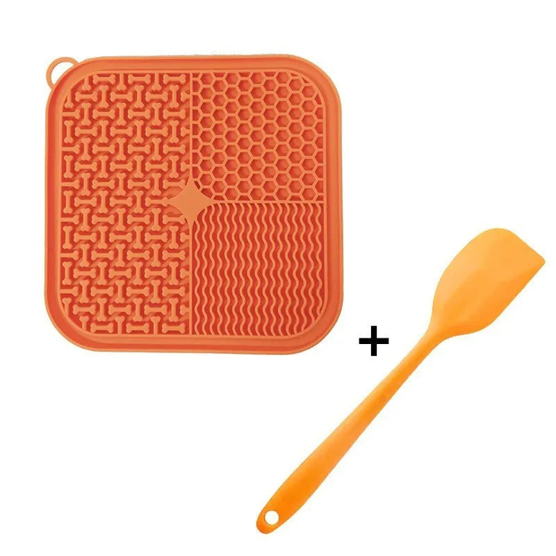 Blue silicone dog lick mat with textured pattern and suction cups on a table.