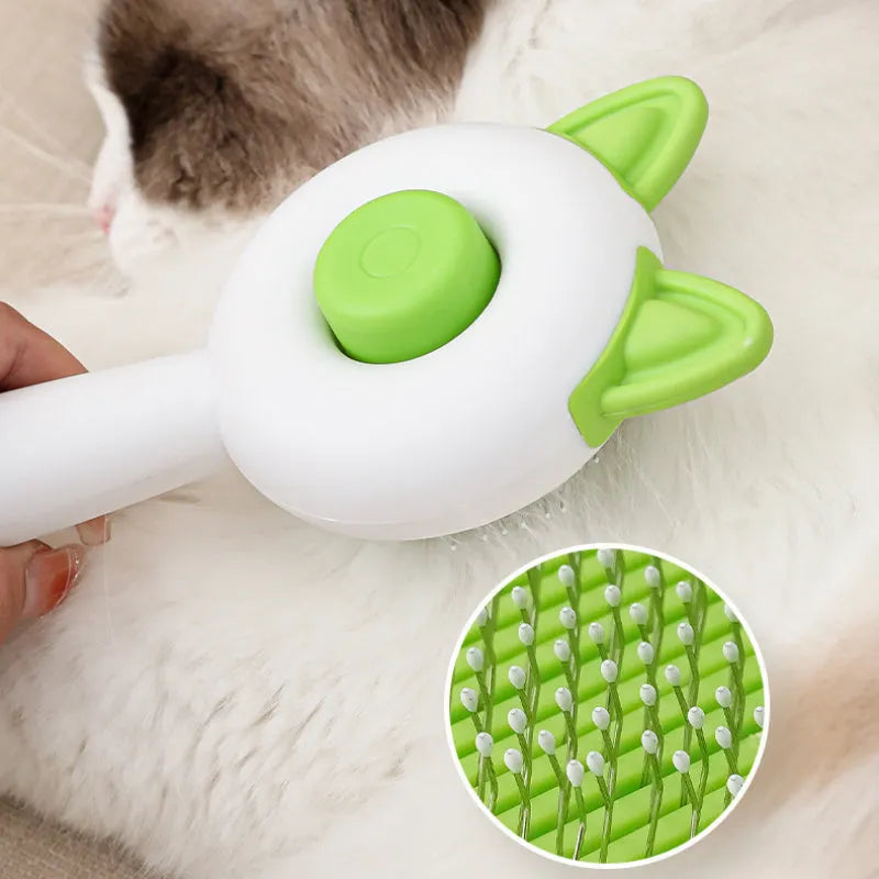 A greenish white and orange cat grooming comb with stainless steel teeth and a self-cleaning button.