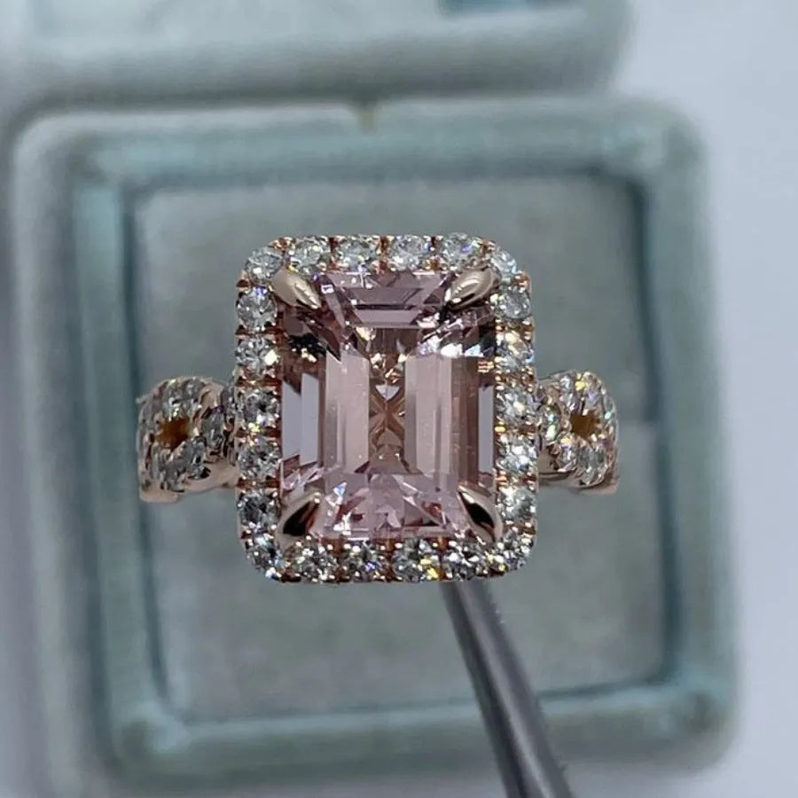 Geometric design rose gold alloy ring on a grey background, showing its clean lines and metallic finish.