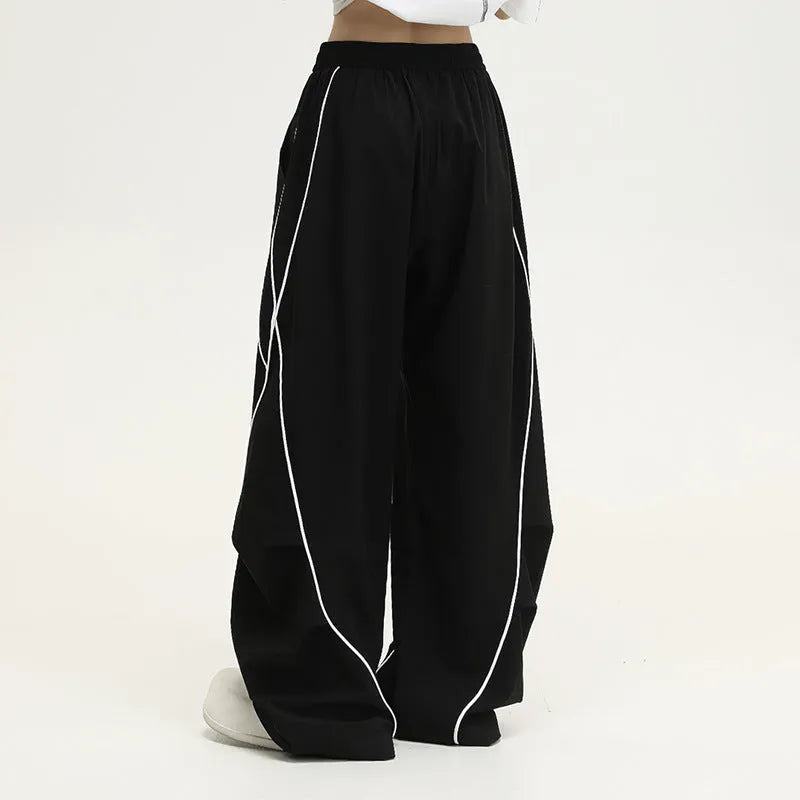 Black pleated wide-leg hip hop pants with striped pattern and mid-waist design made of polyester