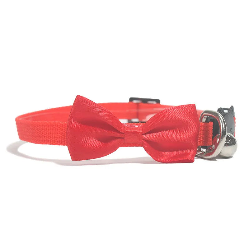 Adjustable striped nylon cat collar with bell in various colors including red, green, and blue