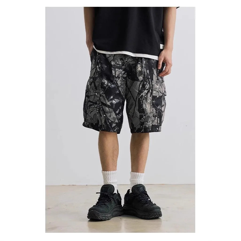 Loose fit straight-leg denim shorts in black shown on a hanger.