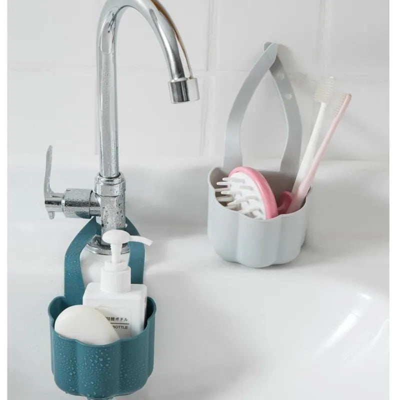Dark blue plastic sink drain basket with Nordic design on a kitchen counter.
