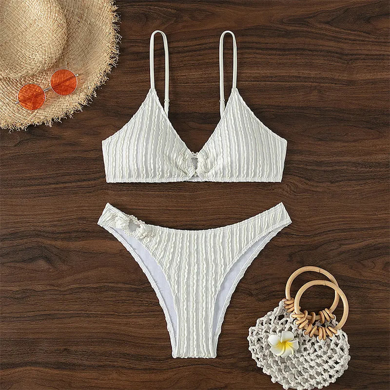 White women's V-neck swimsuit with split beach design, showing top and shorts.