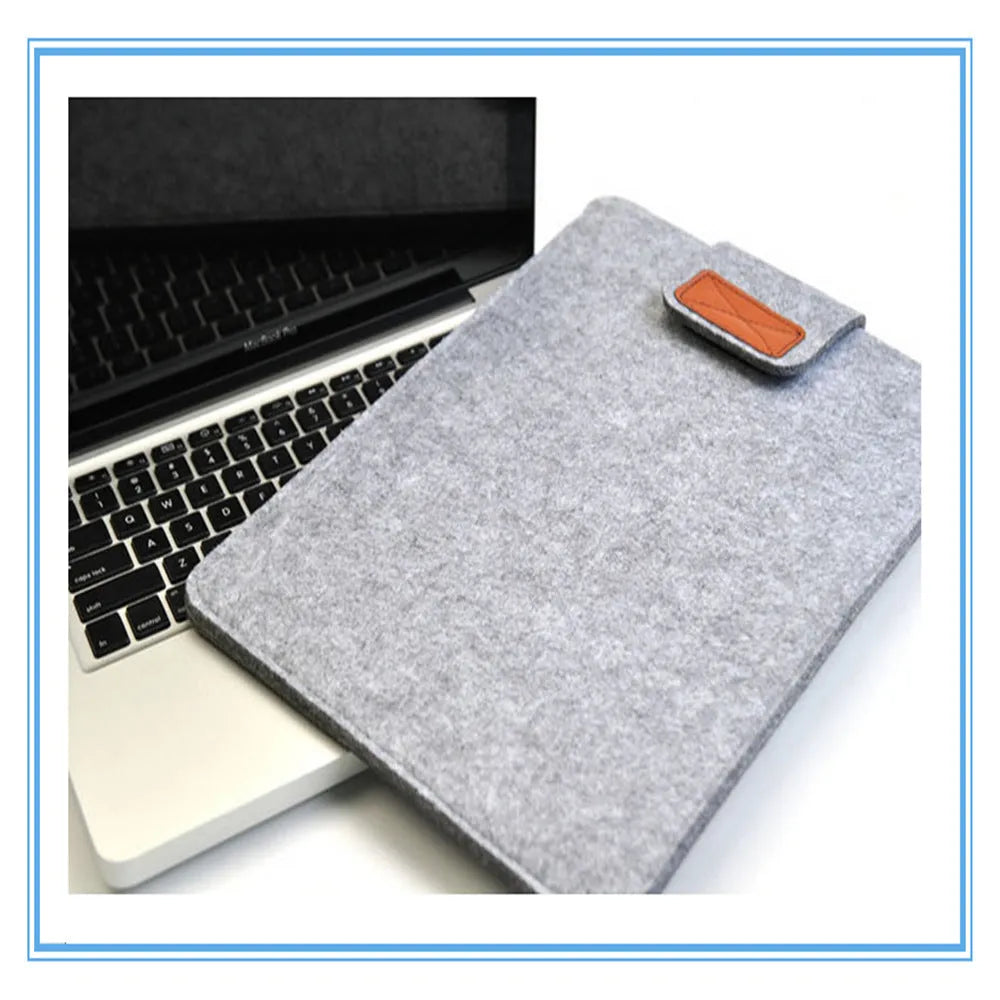 Dark grey felt clamshell laptop bag open to show internal compartment for a tablet