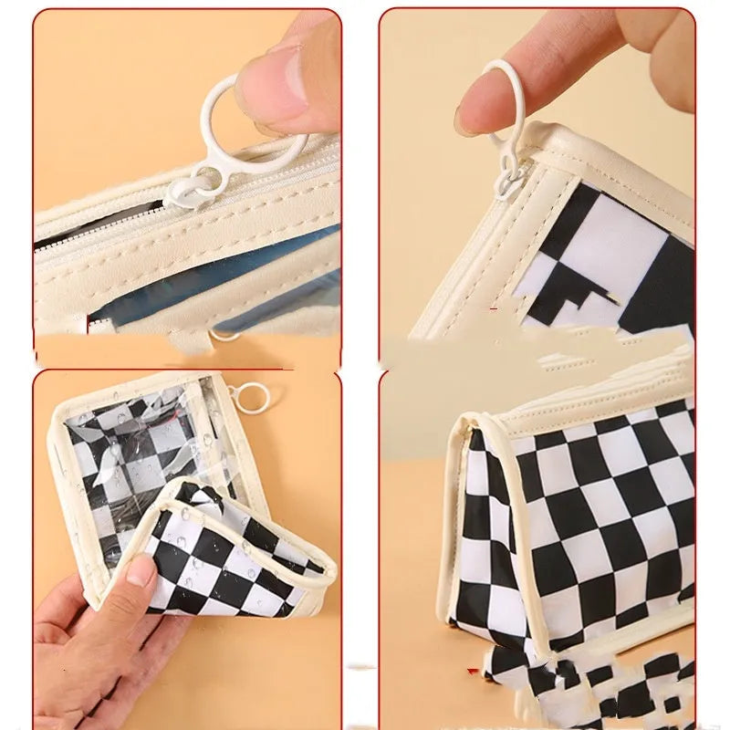 Transparent PVC pencil case with chessboard grid pattern showing pens inside, measuring 21.5cm long