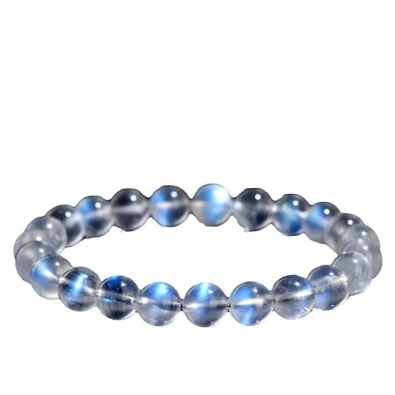 Natural cream body blue moonlight crystal bracelet shown in a simple unisex design on a wrist.