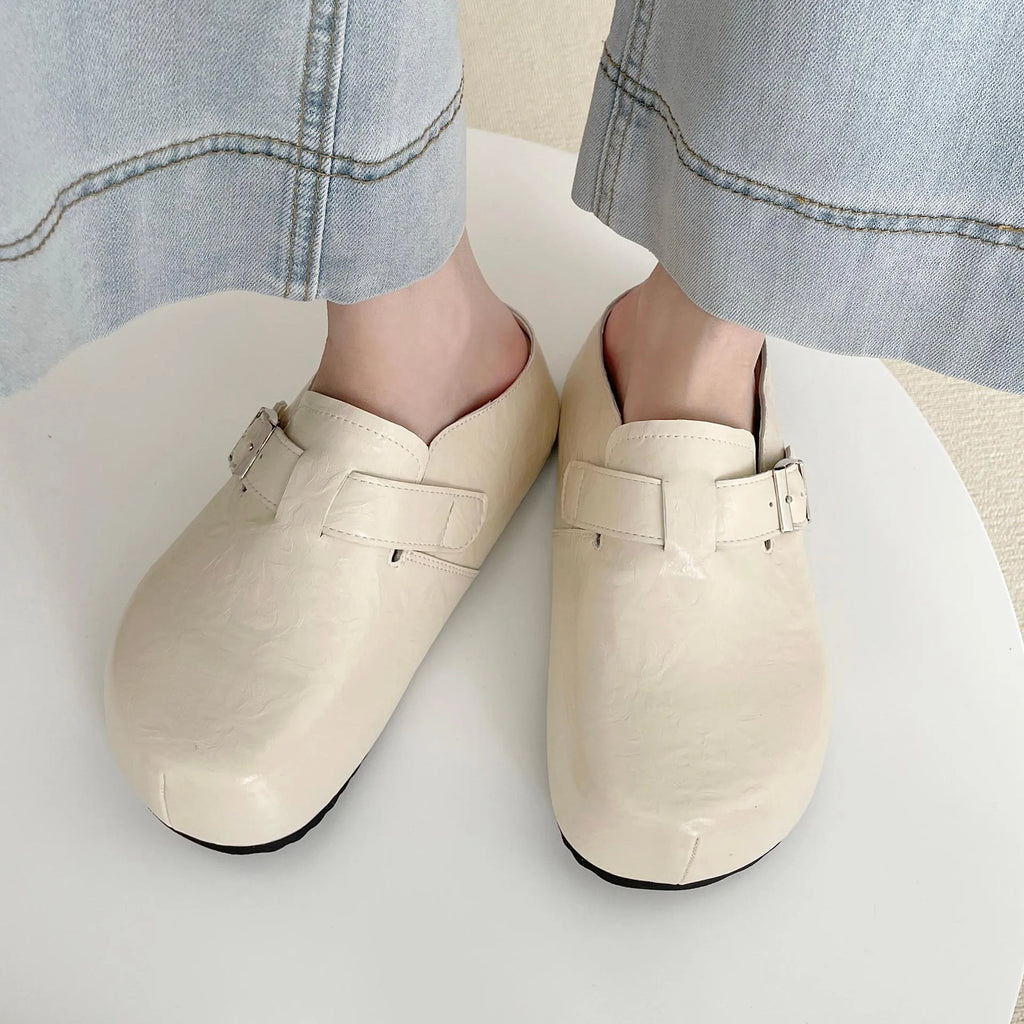 Casual flat buckle sneakers in yellow with round toe, shown on a white background.