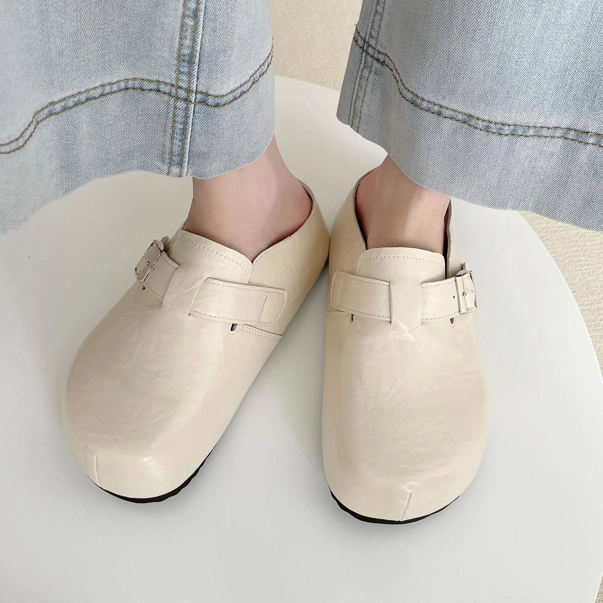 Casual flat buckle sneakers in yellow with round toe, shown on a white background.