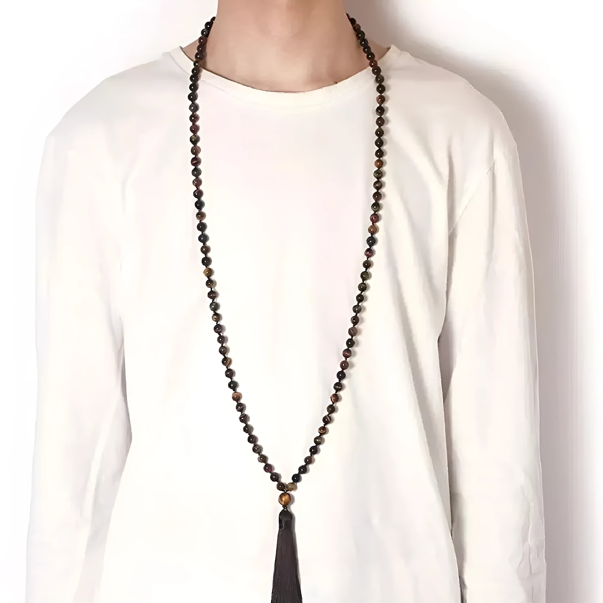 Long beaded agate necklace with geometric stones and a tassel, showing colourful variations.