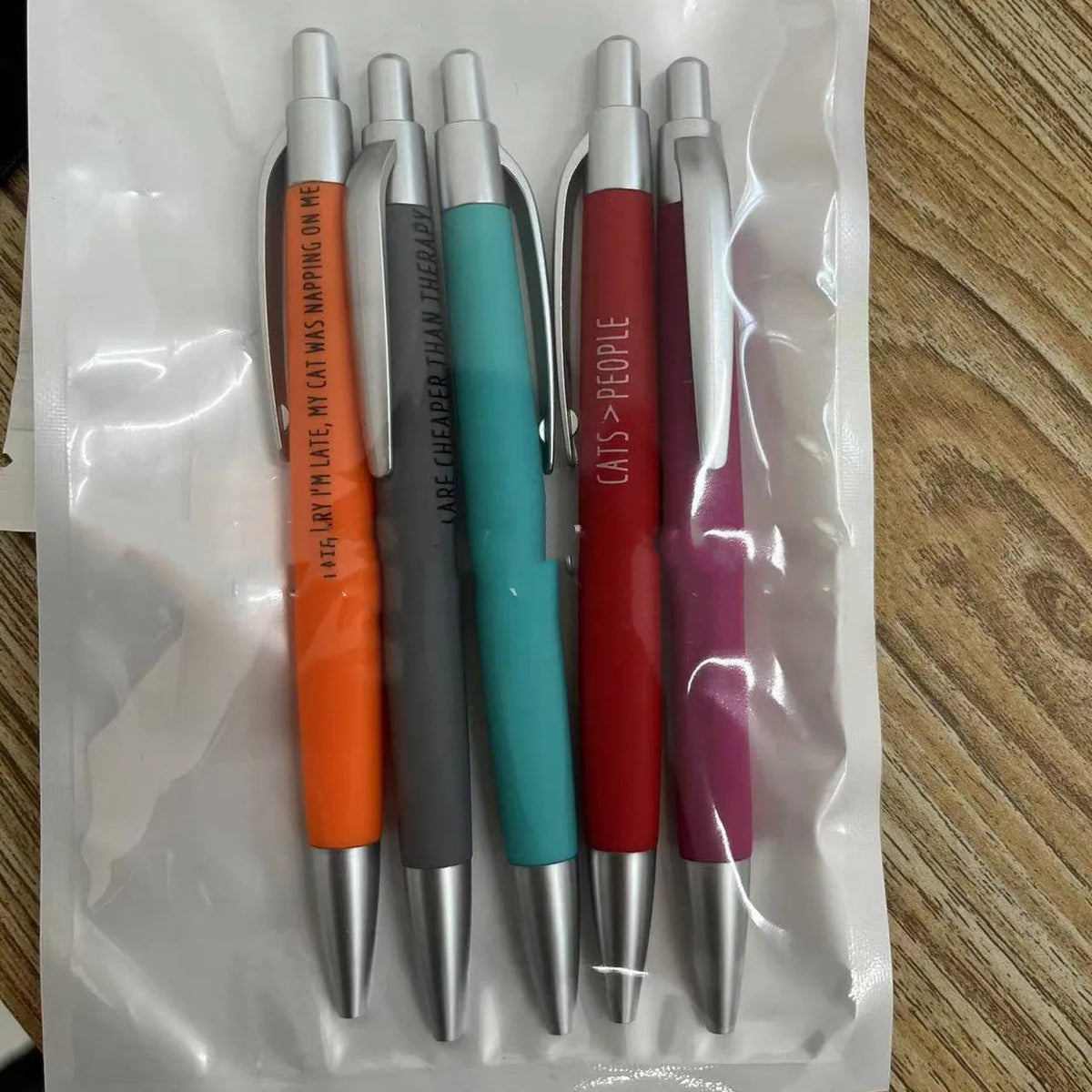 Set of five push-action automatic pens with cat and dog designs in a beaded storage bag.