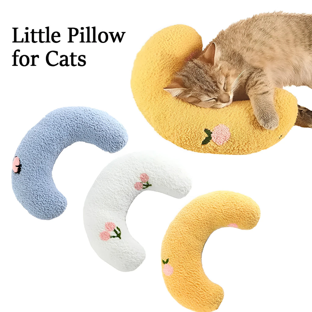 Small blue half-donut shaped pet pillow bed for cats or small dogs on a carpet.