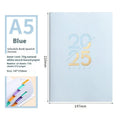 A5 soft faux leather daily planner open on a desk, showing Dorian paper and lay-flat binding.