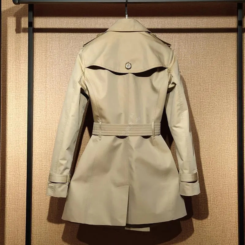 Khaki women's double-breasted trench coat with flight sleeves on a hanger.