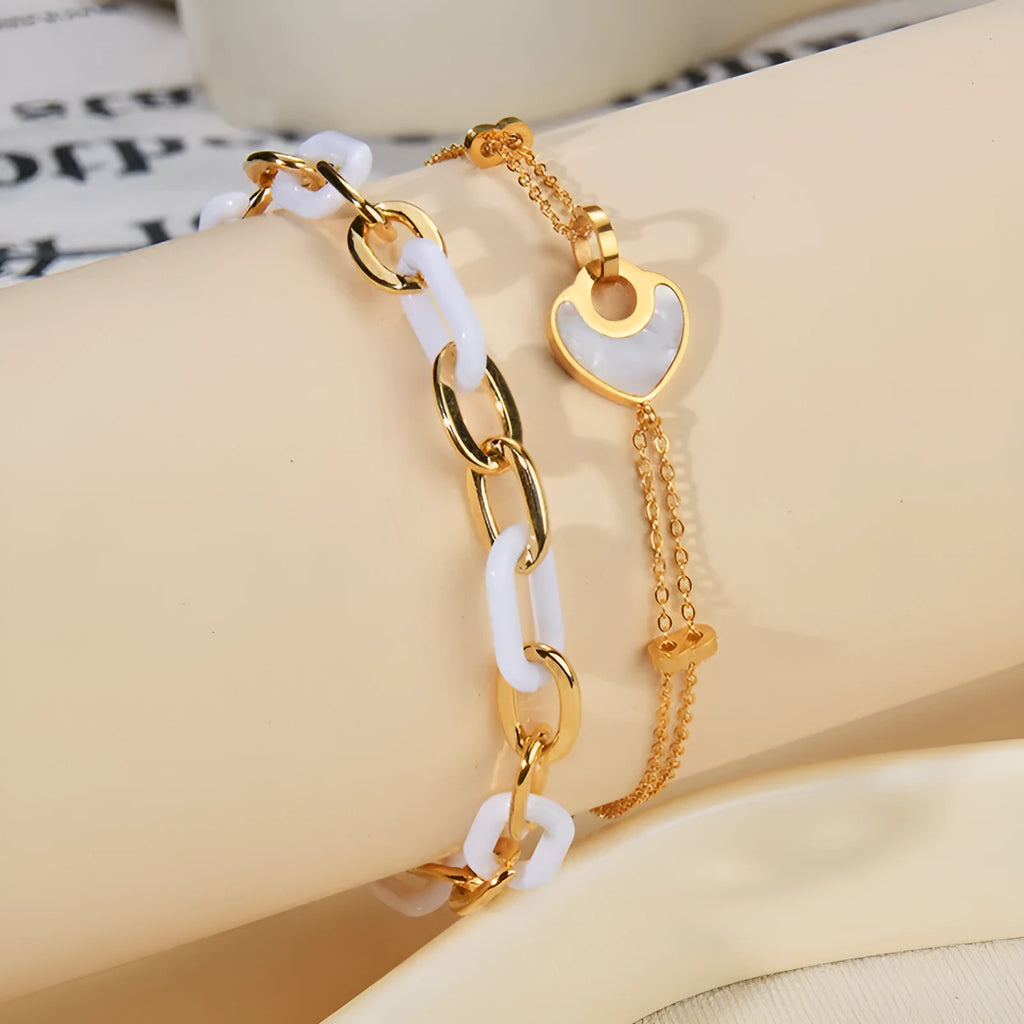 Women's stainless steel bracelet with a double-layer resin heart pendant.