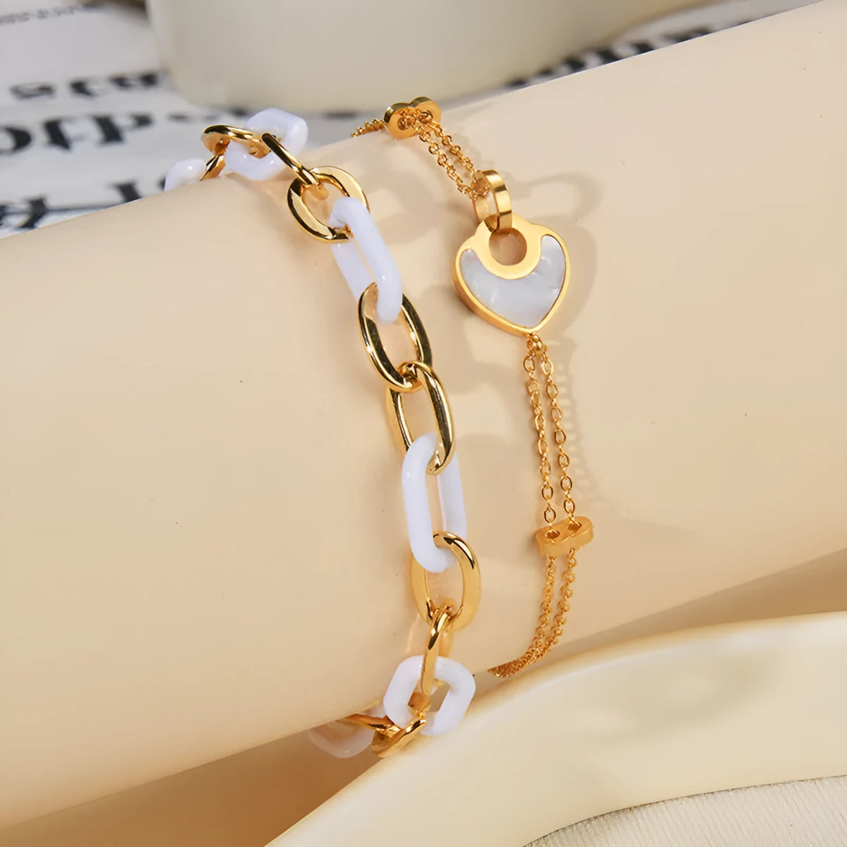 Women's stainless steel bracelet with a double-layer resin heart pendant.