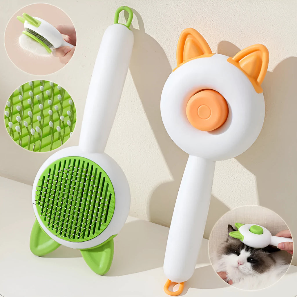 A greenish white and orange cat grooming comb with stainless steel teeth and a self-cleaning button.