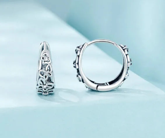 Retro hollow butterfly stud earrings in sterling silver with zircon accents, 14mm by 5mm.