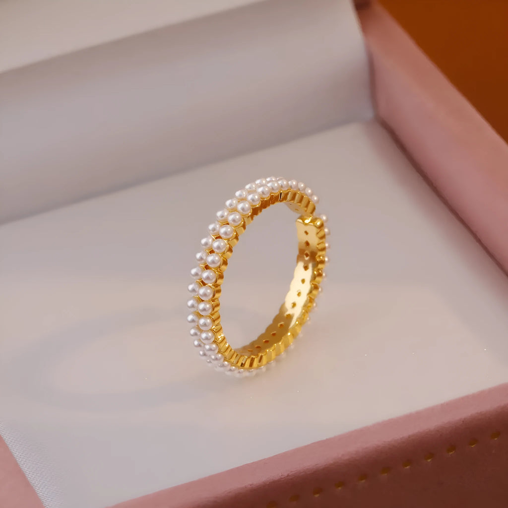 Gold coloured open mouth ring with geometry modelling and round design elements on copper base
