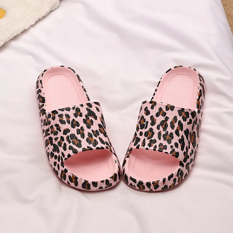 Women's leopard print slippers with thick EVA sole in black, pink, khaki, and white zebra print.