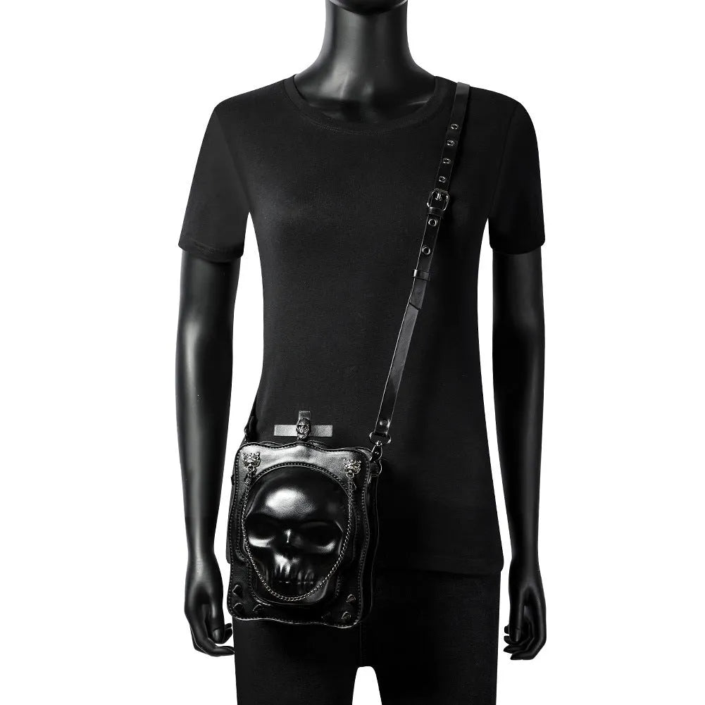 Black Halloween skull shoulder bag with embossed design, chain strap, and vertical square messenger shape