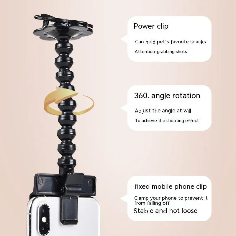 Black pet photography tool with rotating mount and phone clip for holding treats during animal photoshoots