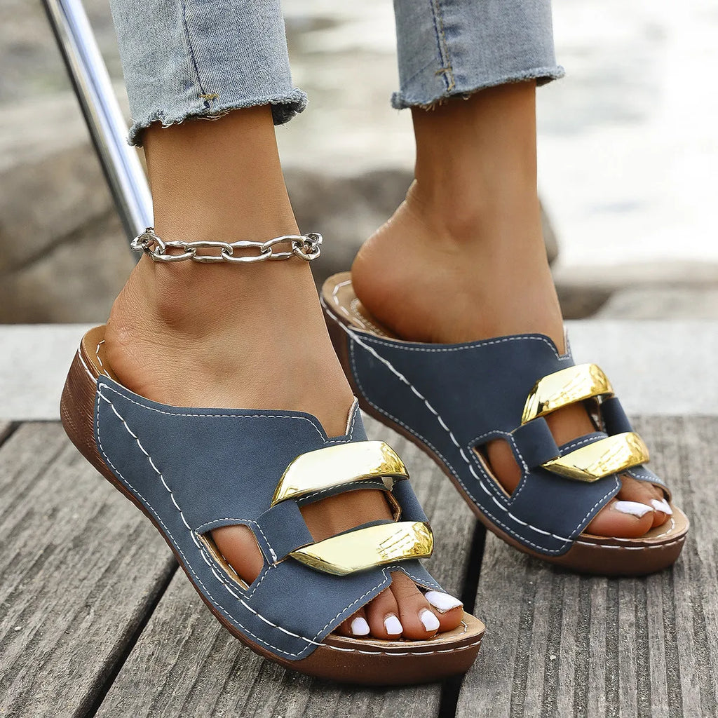 Women's white Roman style platform sandals with metal detail on a flat rubber sole.