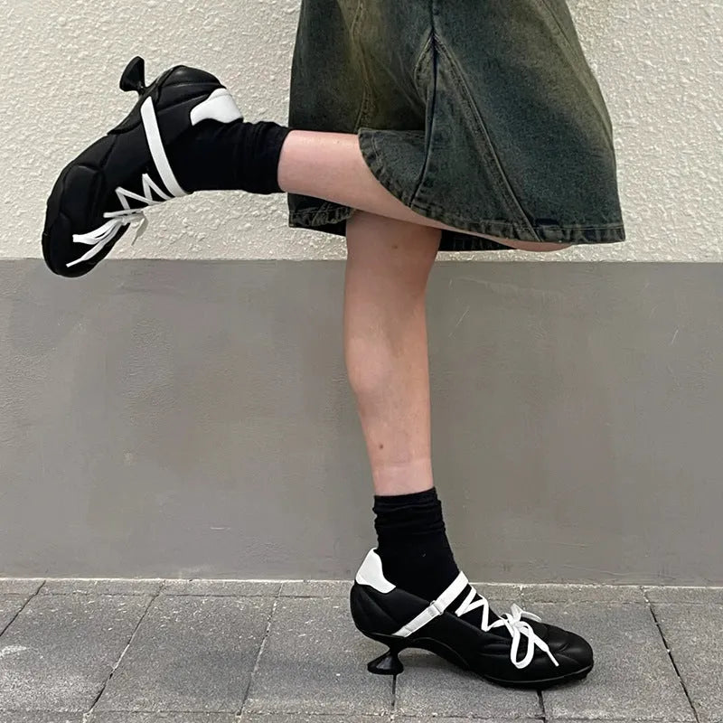 Women's silver sports shoes with lace-up front and decorative bow detail on microfiber upper