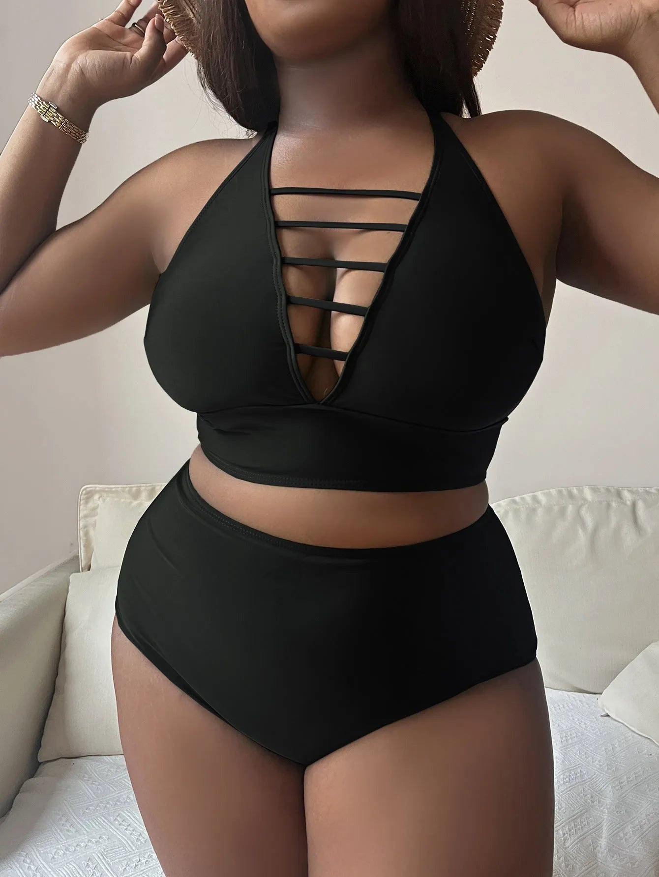 Plus size black halter bikini set with adjustable straps and high-waisted briefs on a mannequin