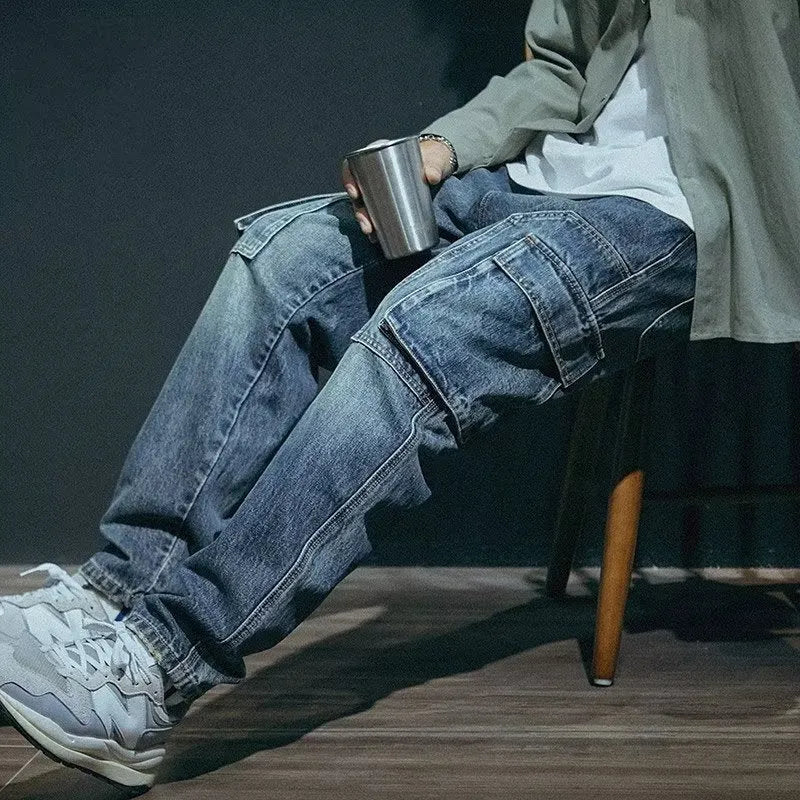 Blue men's loose straight-leg retro-style stretch denim trousers on a plain background.