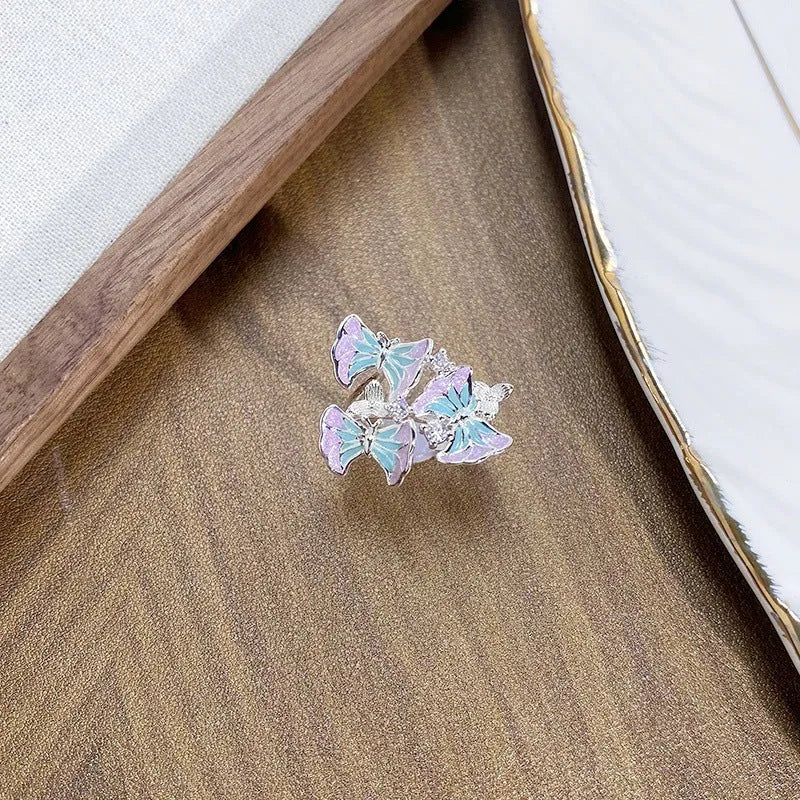 Adjustable copper insect motif ring with textured drip oil finish shown in available colour variations