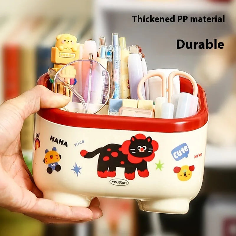 Cartoon-style plastic desktop organiser with grid compartments and labelling stickers for stationery storage