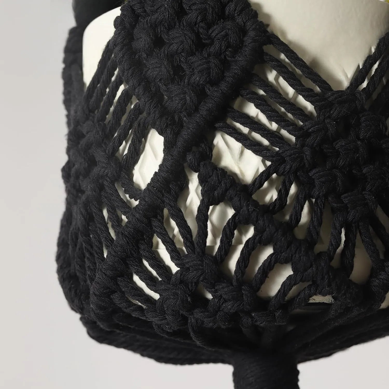 Hand-woven brown polyester cotton net pocket extension cord on a grey flower pot.