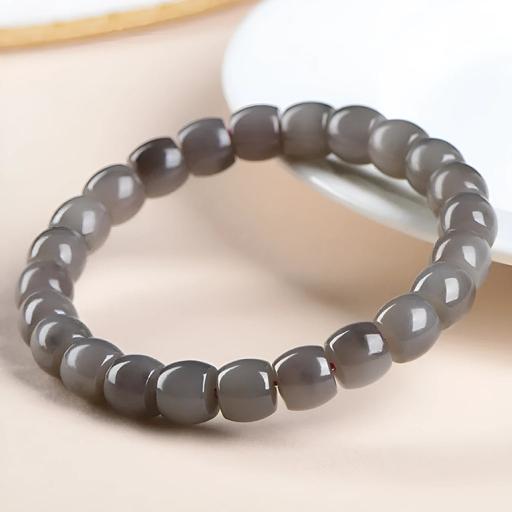 Natural smokey violet Hetian jade bracelet with straight cut beads on a wrist.