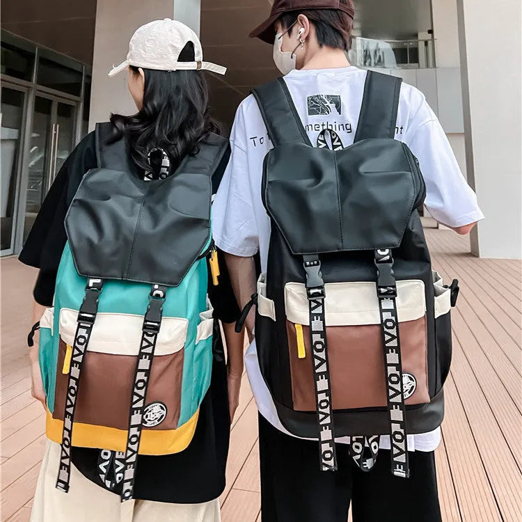 Oxford cloth school backpack in black, green, or red with handheld, shoulder and backpack carrying options