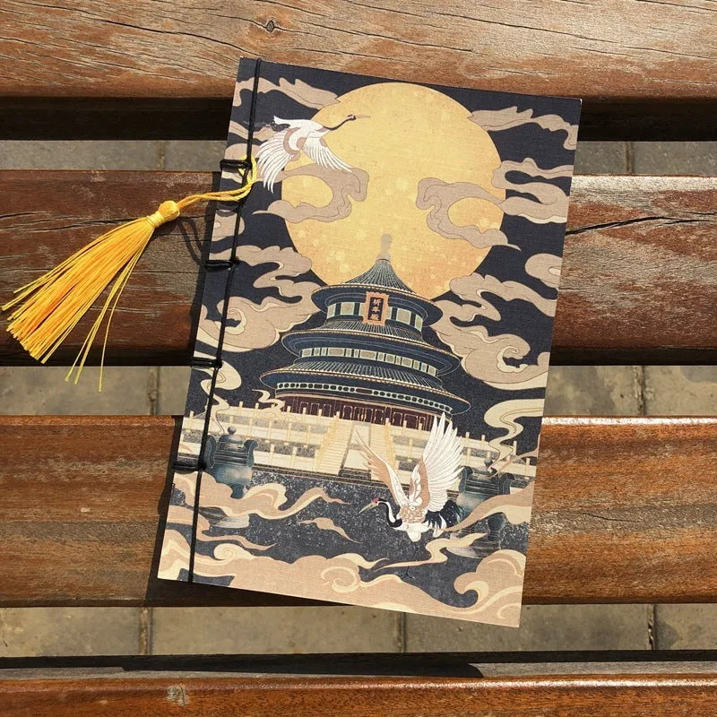 A5 antique wire-bound notebook with glossy embossed cover featuring a retro painting design, shown open.