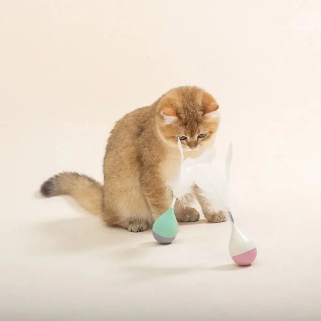 Green and pink feather tumbler cat toy with ABS plastic ball and goose feather attachment