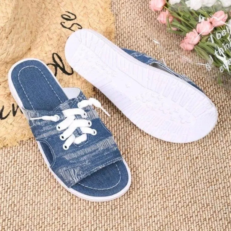 Blue Roman style flat canvas slippers for women with a rubber sole.