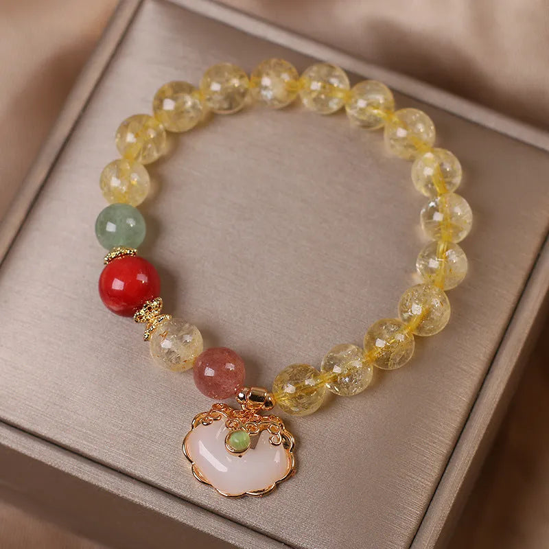 Yellow citrine jade ruyi pendant on an alloy women's bracelet.