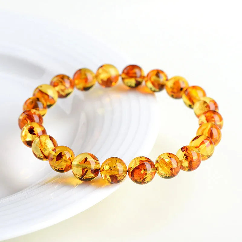 Natural yellow piebald amber bracelet with geometric beads in polished finish