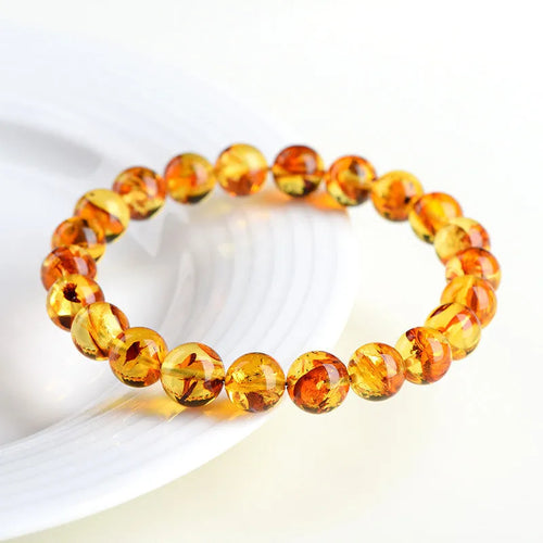 Natural yellow piebald amber bracelet with geometric beads in polished finish