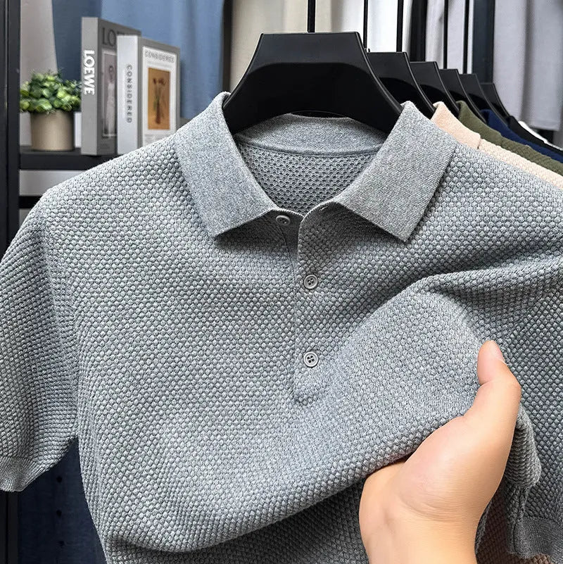 A loose-fitting short sleeve cotton pullover sweater on a hanger, shown in one of the six available colours.