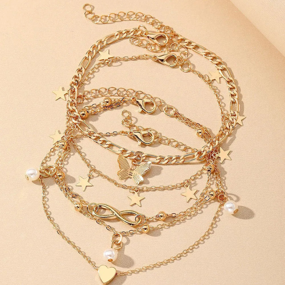 Butterfly pearl heart anklet set containing four alloy foot chain jewellery pieces for women