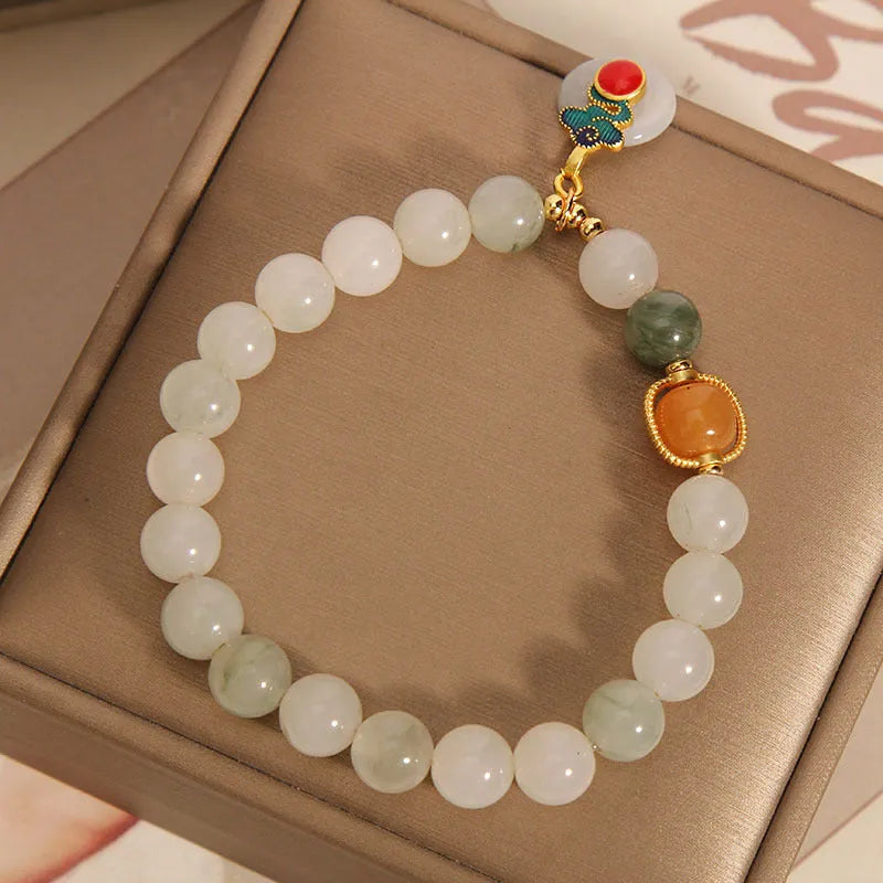 Women's ice jade bracelet with pearl accents and traditional Xiangyun peace buckle closure