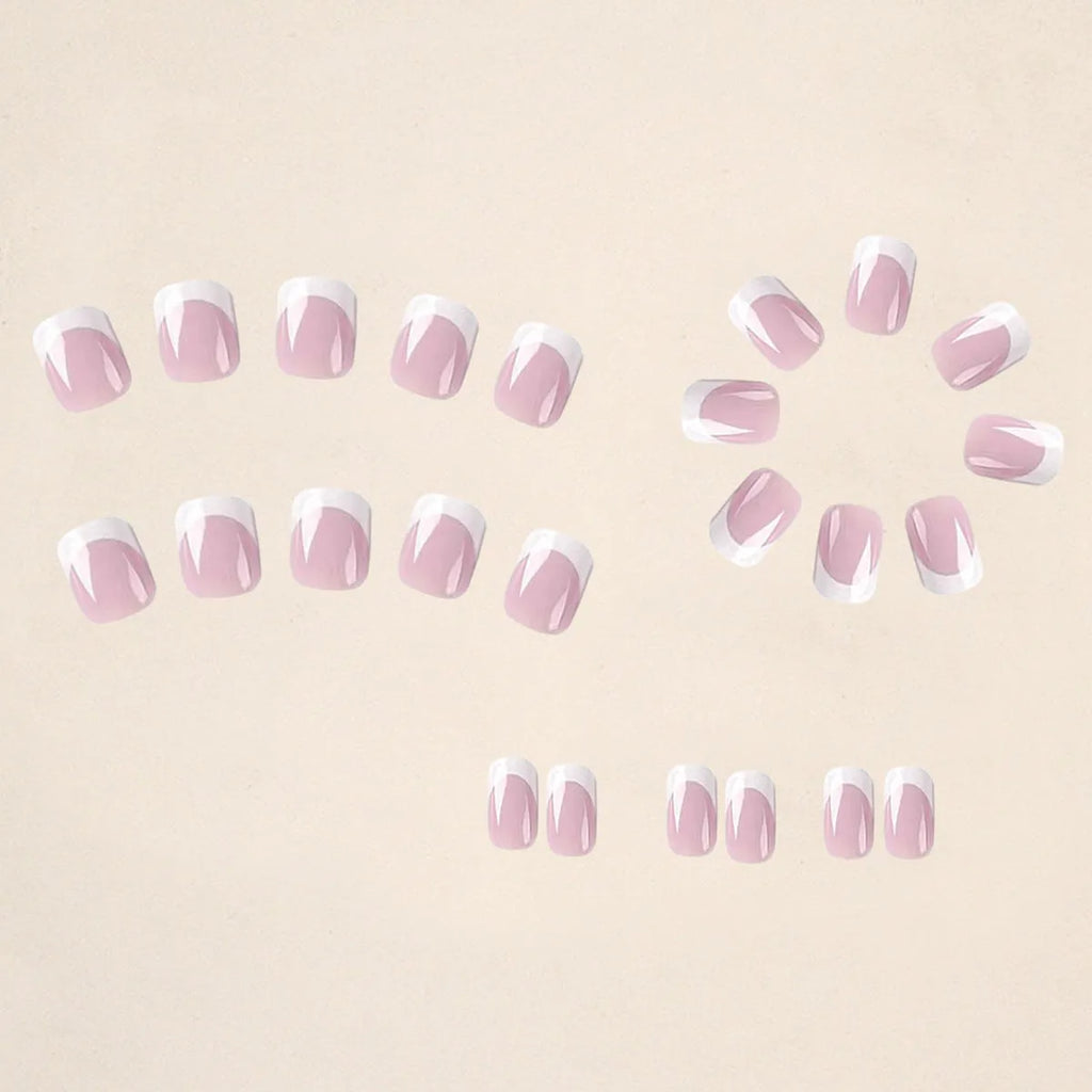24 white square fake nails with a black and white plaid pattern design laid out on a surface.