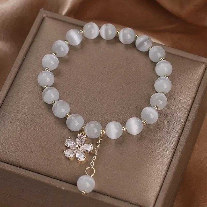 Women's white cat's eye crystal bracelet with flower tassels and morganite safety buckle pendant