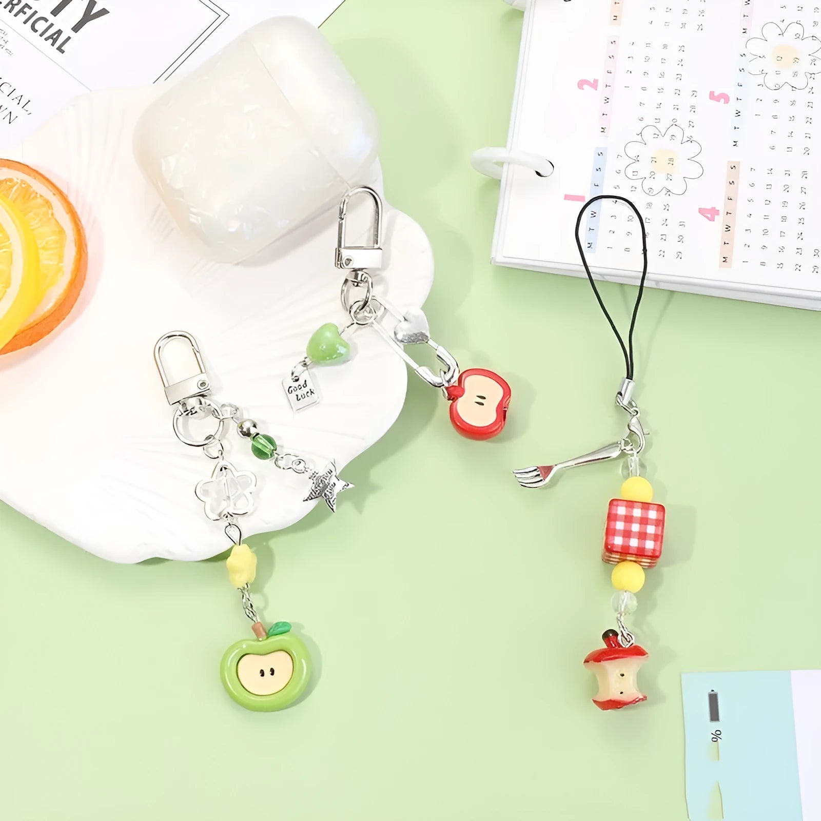 Plastic resin iPhone charm bag pendant keychain with fruit patterns including apple core and strawberry designs