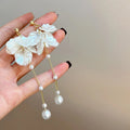 Women's shell-shaped pearl tassel earrings with four clip style options measuring 8.8cm long