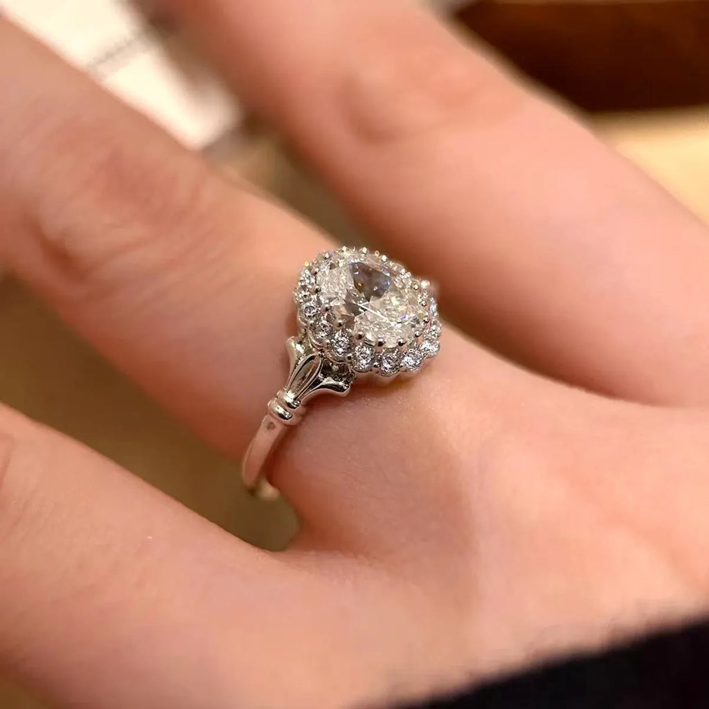 Silver adjustable diamond ring with geometric ellipse shape on finger